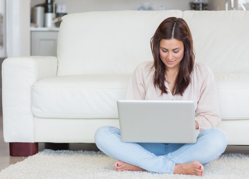Woman filling out electronic intake form at home